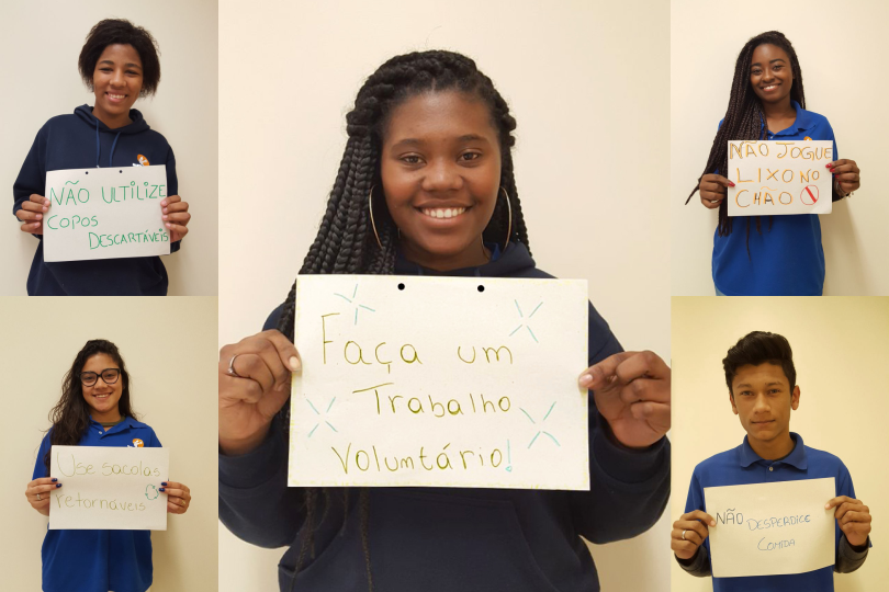 Alunos da atual turma do Projeto Pescar mostram mensagens de temática socioambiental e convidam as pessoas a fazer voluntariado.