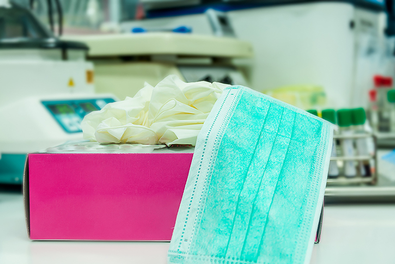 Fotografia de caixa de luvas e máscara de uso médico