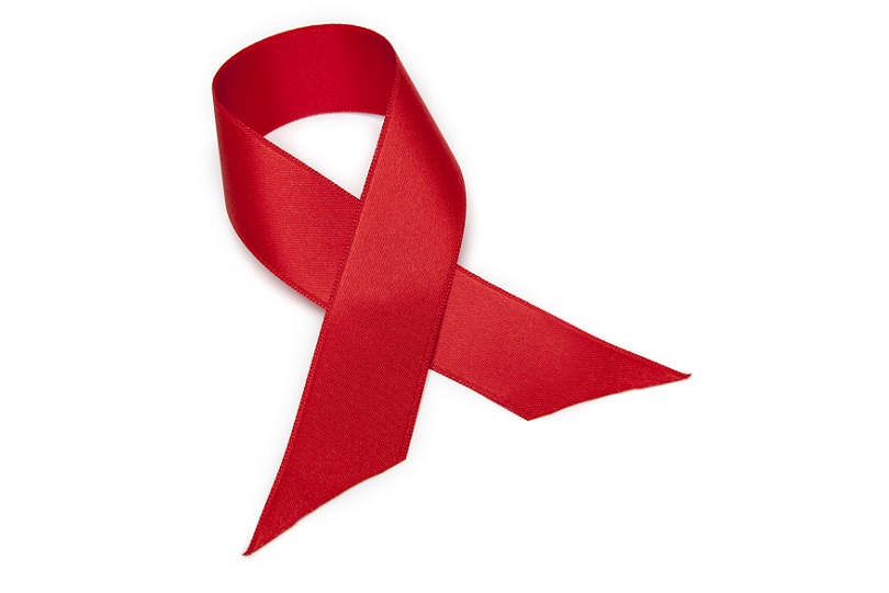 Imagem de laço vermelho sobre fundo branco. Laço é o símbolo do Dia Mundial de Luta contra a Aids.