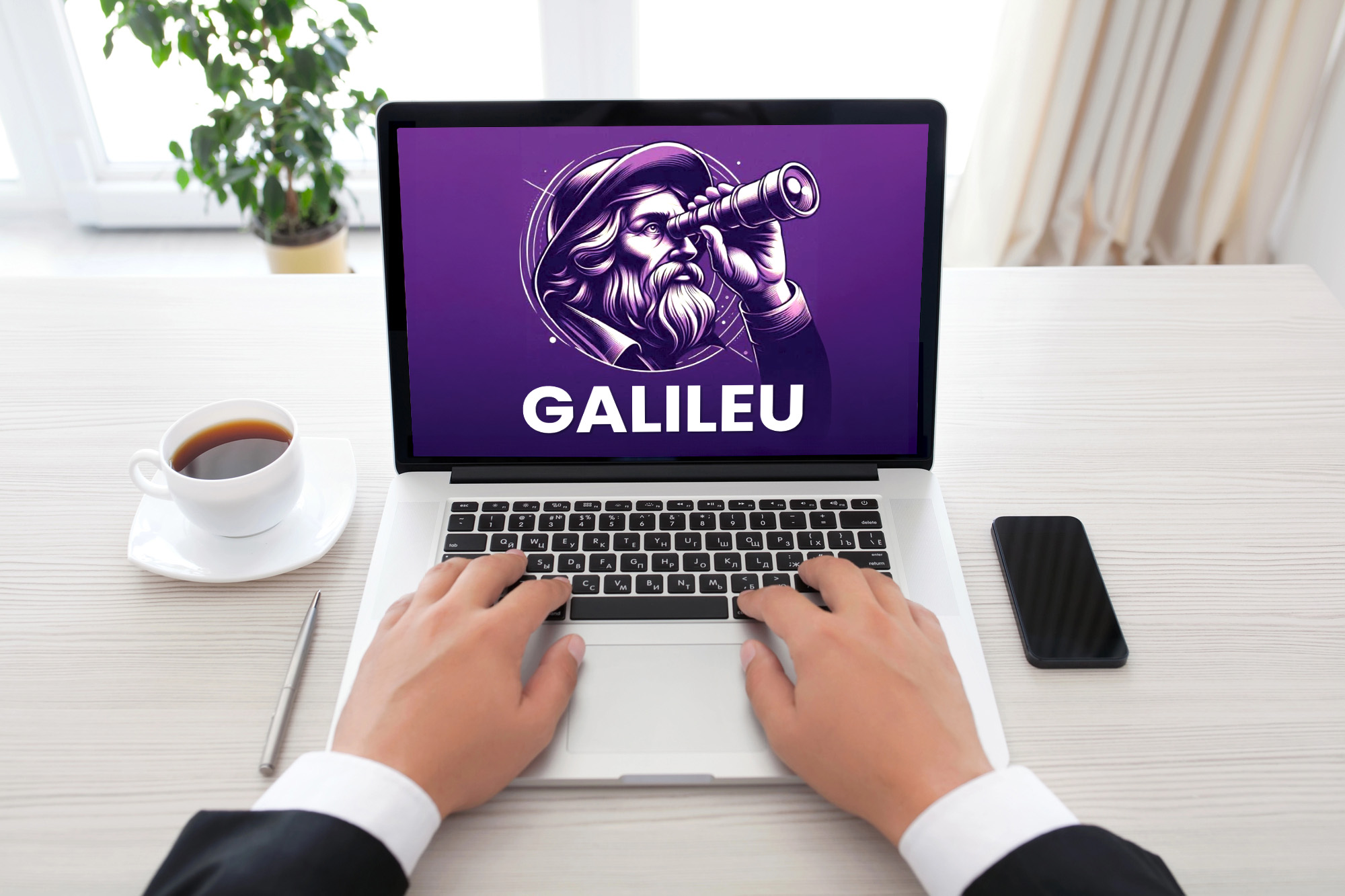Imagem ilustrativa das mãos de uma pessoa usando um notebook. Na tela aparece o logo do sistema Galileu, com o desenho de uma pessoa de barba comprida usando uma luneta.
