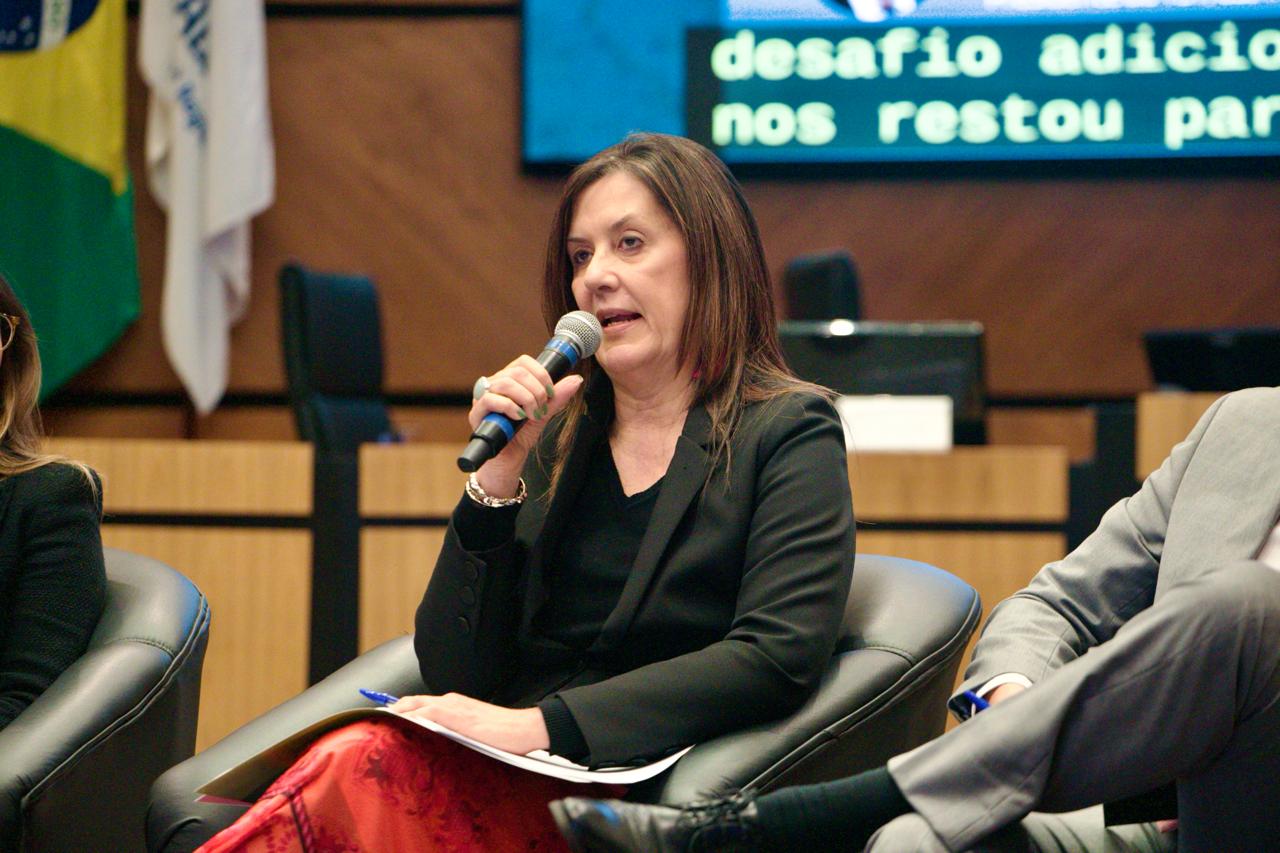 A foto mostra a desembargadora Beatriz discursando.