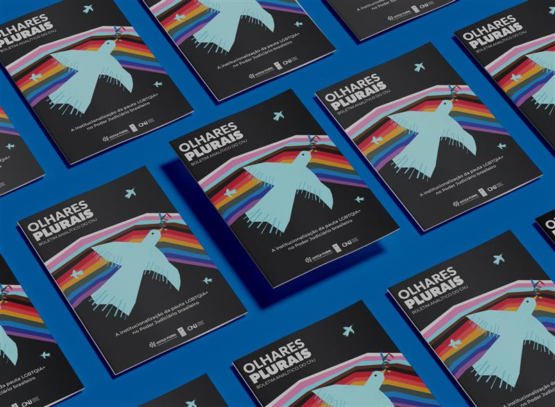 Mockup do relatório. O fundo é preto, com uma pomba ao centro, atrás dela tem o arco-íris com as cores do movimento LGBTQIAPN+.