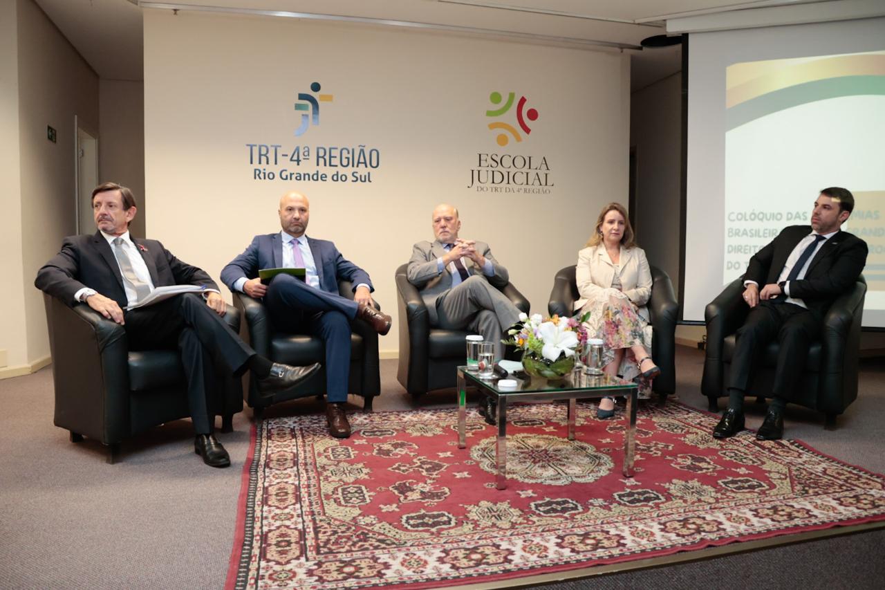 Participantes da mesa de abertura, sentados.