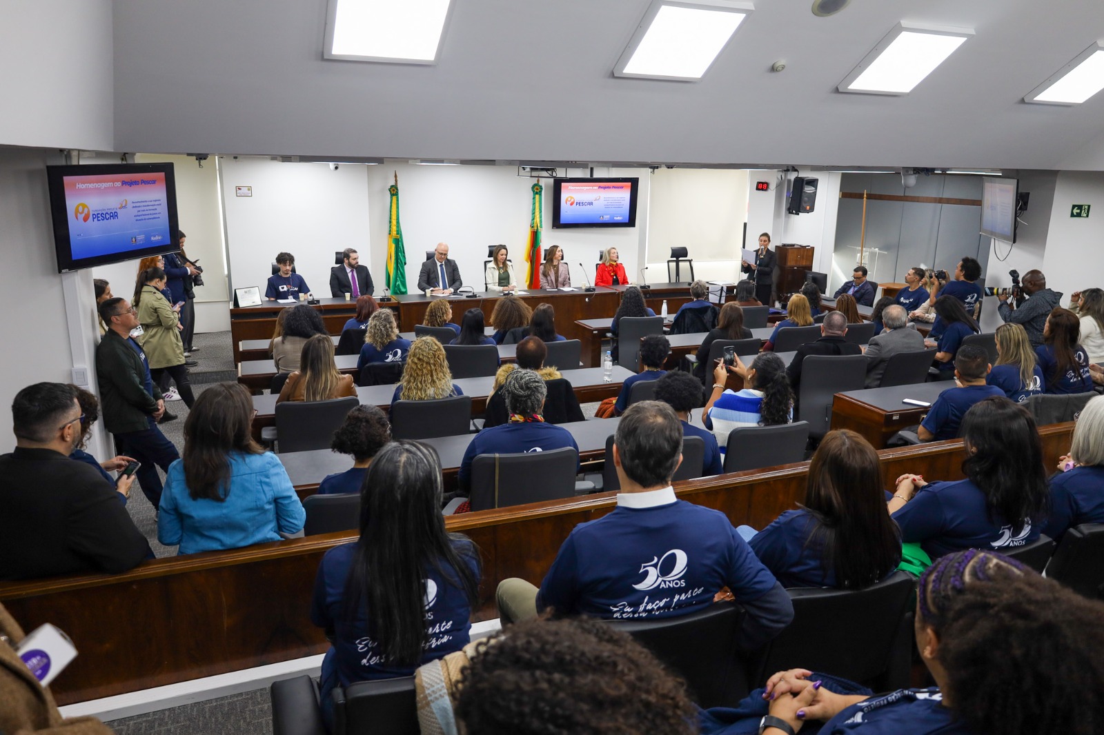 A foto mostra autoridades e público de fundo.