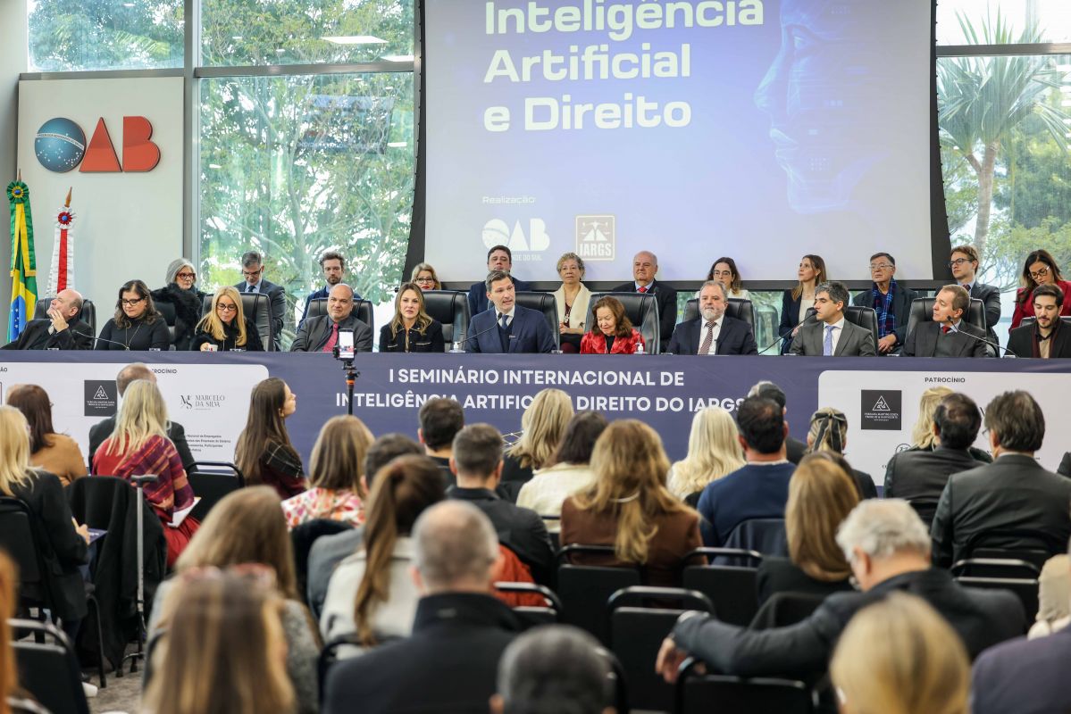 Foto em ângulo aberto do evento, mostrando público e mesa de autoridades.