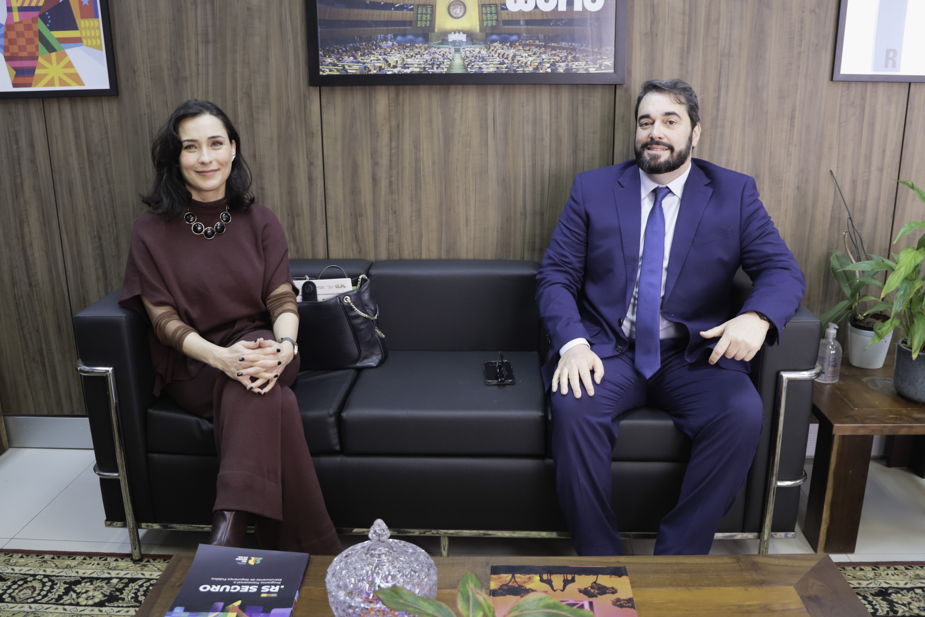 Débora e Alexandre estão sentados em um sofá no gabinete da presidência