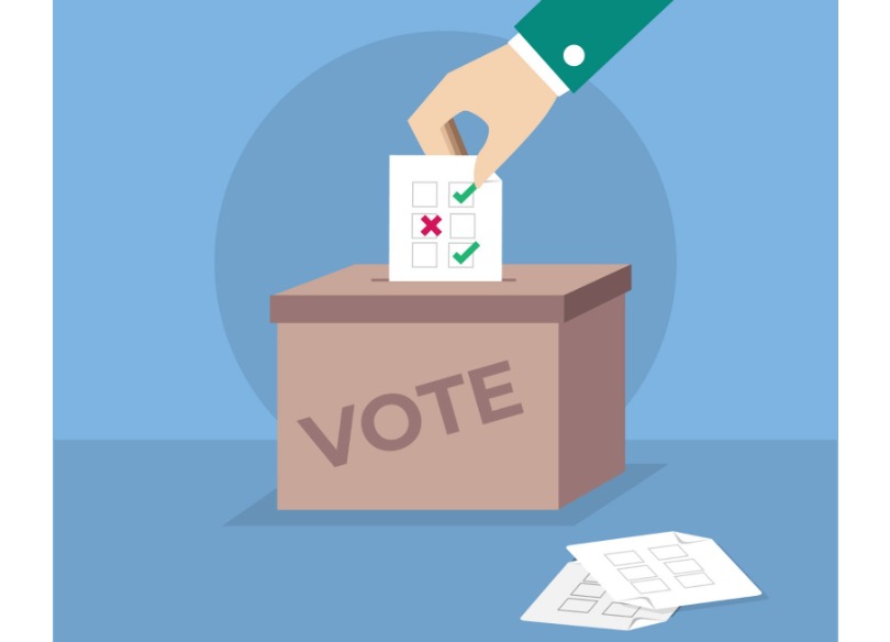 Imagem de um urna recebendo um papel de votação.