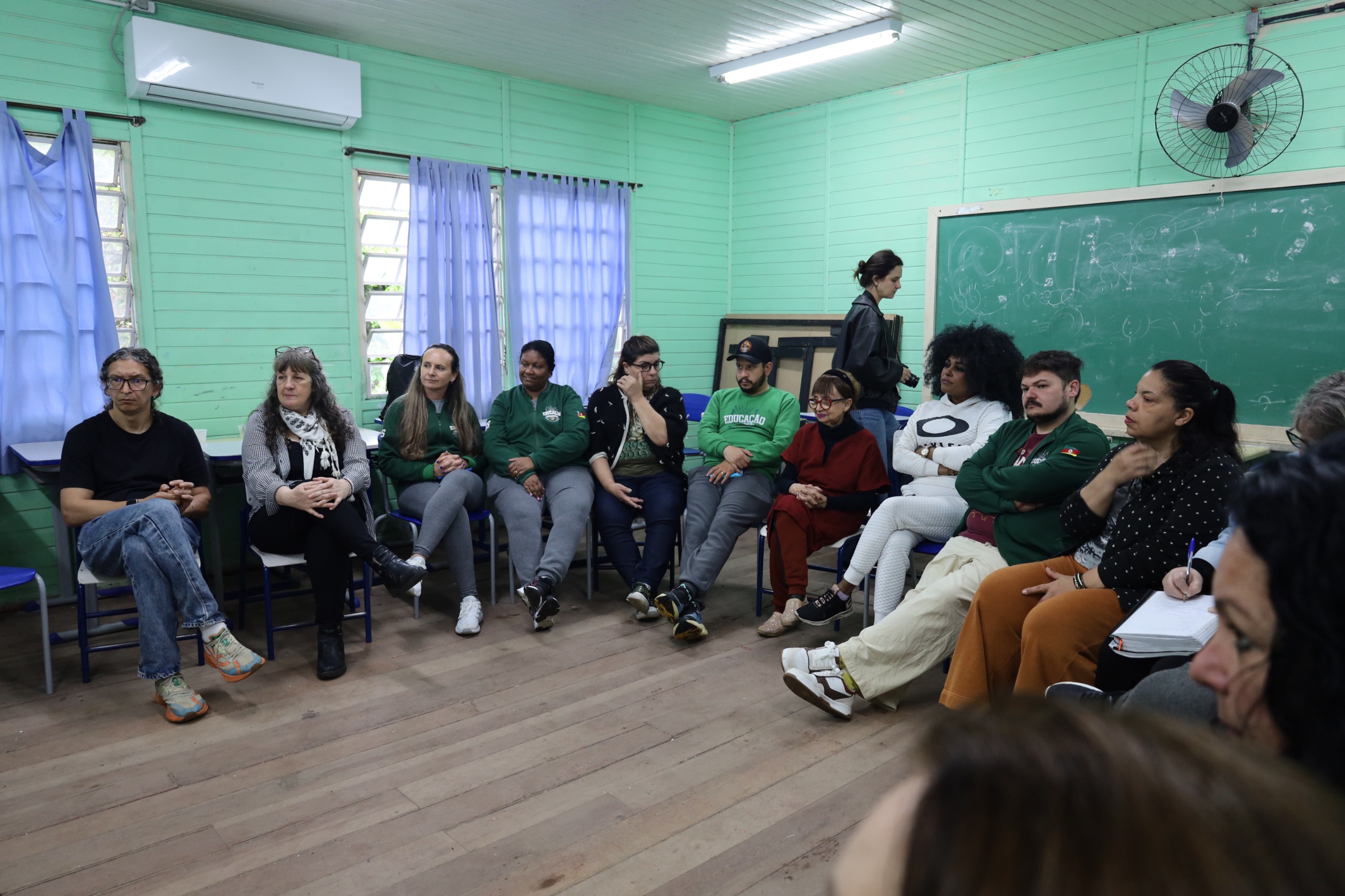 Professores sentados assistindo o discurso