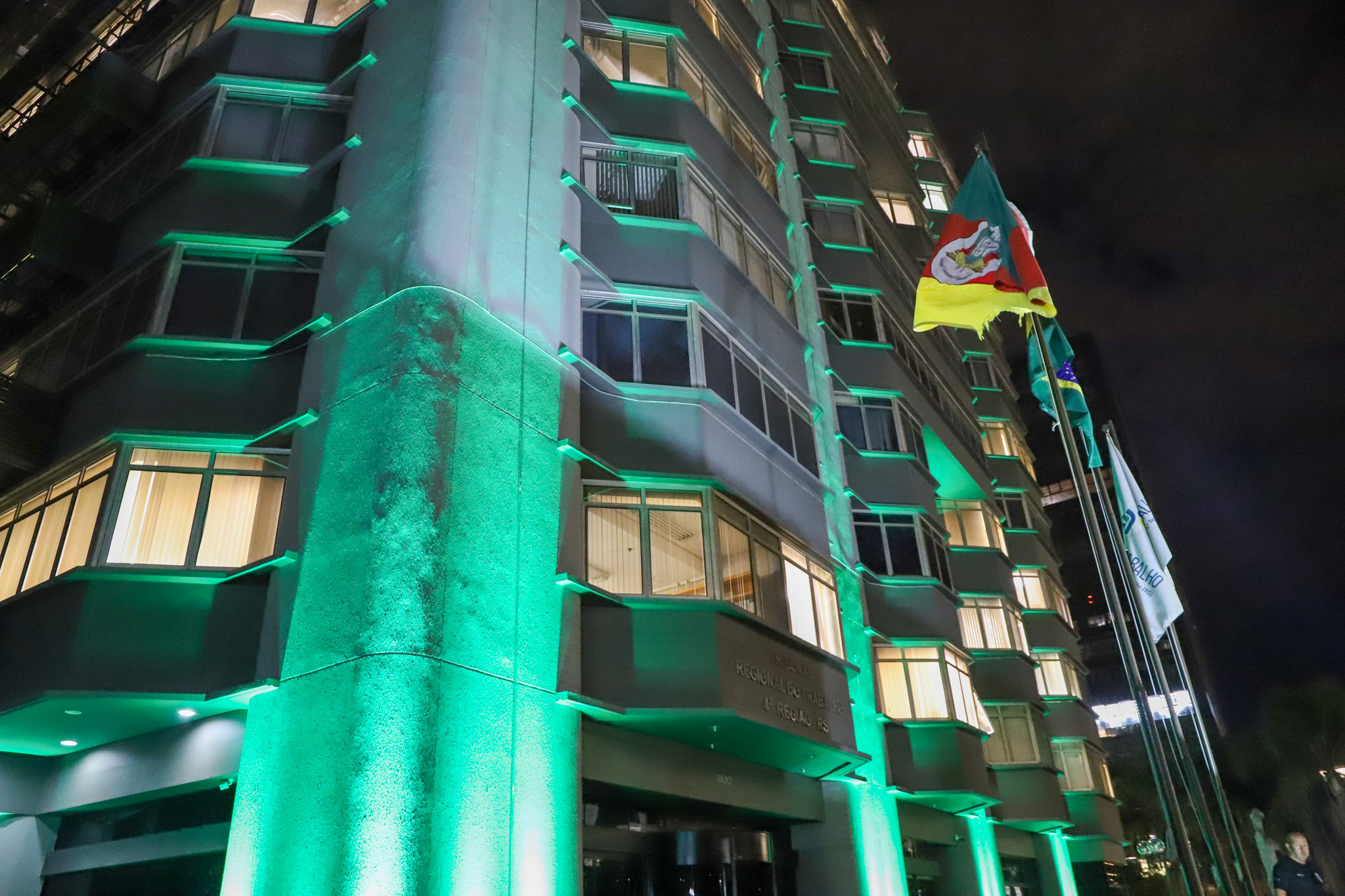 Foto do prédio do TRT-4 iluminado de verde.
