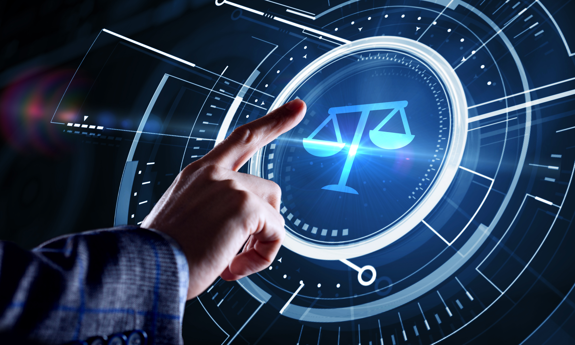 Imagem de uma mão com o dedo indicador esticado indo em direção ao símbolo da balança da Justiça em formato digital. 