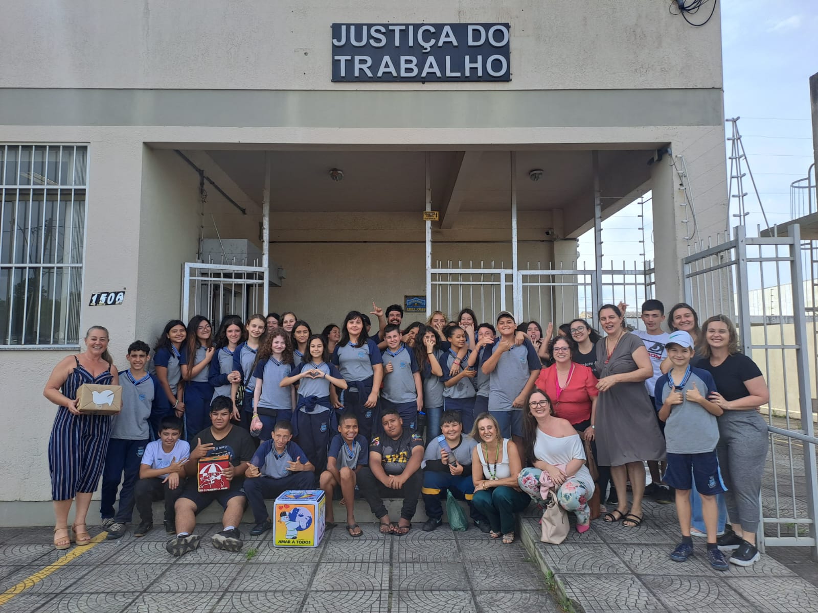 Magistrados, professores, integrantes do projeto e alunos em frente ao Posto da JT em Tramandaí